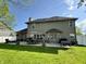 Spacious backyard with concrete patio, outdoor dining area, grill, and green grass at 6360 E Chapel Hill Ct, Camby, IN 46113