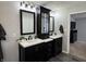 Elegant bathroom featuring double vanities with modern fixtures, mirrors, and a view to an adjacent bedroom at 6360 E Chapel Hill Ct, Camby, IN 46113