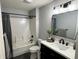 Modern bathroom featuring a tub/shower combo with sleek fixtures and a contemporary vanity with decorative accents at 6360 E Chapel Hill Ct, Camby, IN 46113