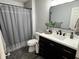 Modern bathroom with a dark vanity, white countertop, gray accents, and stylish decor at 6360 E Chapel Hill Ct, Camby, IN 46113