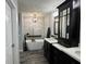 Stylish bathroom boasting a freestanding tub, double vanity, modern lighting, and artistic decor for a serene atmosphere at 6360 E Chapel Hill Ct, Camby, IN 46113