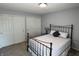 Comfortable bedroom with an iron bed frame, neutral carpet, and double-door closets at 6360 E Chapel Hill Ct, Camby, IN 46113