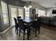 This dining area features modern lighting, tiled floors and is conveniently open to the adjacent living room at 6360 E Chapel Hill Ct, Camby, IN 46113