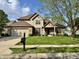 Charming two-story home with a manicured lawn, brick accents, and attached two-car garage at 6360 E Chapel Hill Ct, Camby, IN 46113