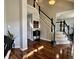 Grand foyer with hardwood floors, staircase, and views into the living room, creating an inviting entrance at 6360 E Chapel Hill Ct, Camby, IN 46113