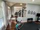 Bright home gym features hardwood floors, a staircase, motivational decor, and exercise equipment at 6360 E Chapel Hill Ct, Camby, IN 46113