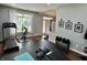 Bright home gym features hardwood floors, workout equipment, natural light, and motivational decor at 6360 E Chapel Hill Ct, Camby, IN 46113