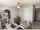 Comfortable home office features a ceiling fan, natural light, a desk, and a storage unit at 6360 E Chapel Hill Ct, Camby, IN 46113