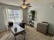 Comfortable home office features a ceiling fan, natural light, a desk, and a storage unit at 6360 E Chapel Hill Ct, Camby, IN 46113
