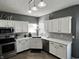 This lovely kitchen features stainless steel appliances, modern lighting, white cabinets, and granite countertops at 6360 E Chapel Hill Ct, Camby, IN 46113
