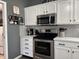 This beautifully designed kitchen boasts stainless steel appliances, granite countertops, and stylish subway tile backsplash at 6360 E Chapel Hill Ct, Camby, IN 46113