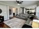 Comfortable living room with sectional seating, large windows, and access to the kitchen creating an open layout at 6360 E Chapel Hill Ct, Camby, IN 46113