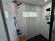 Modern shower featuring stylish tilework, multiple showerheads, built-in shelving and a window for natural light at 6360 E Chapel Hill Ct, Camby, IN 46113