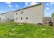 View of the exterior, including backyard with lawn at 7163 Cordova Dr, Indianapolis, IN 46221