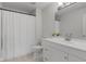 White bathroom with a vanity and mirror, a toilet, and a shower with a curtain at 7163 Cordova Dr, Indianapolis, IN 46221