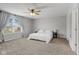 Neutral bedroom features a large window with natural light, ceiling fan, and carpeted floors at 7163 Cordova Dr, Indianapolis, IN 46221