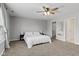 Spacious bedroom with a ceiling fan, carpeted floors, and neutral paint at 7163 Cordova Dr, Indianapolis, IN 46221