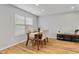Dining area featuring a wood table with four chairs, stylish decor, and wood flooring at 7163 Cordova Dr, Indianapolis, IN 46221