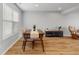 Dining area featuring wood flooring, a modern table with four chairs, and a brightly lit window at 7163 Cordova Dr, Indianapolis, IN 46221