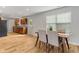 Open-concept dining area with wood floors, adjacent to the kitchen, featuring a wooden table and chairs at 7163 Cordova Dr, Indianapolis, IN 46221