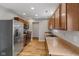 Well-lit kitchen features stainless steel appliances, wood cabinets, and wood-look flooring at 7163 Cordova Dr, Indianapolis, IN 46221