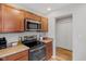 Modern kitchen with stainless steel appliances, wood cabinets, and updated countertops and flooring at 7163 Cordova Dr, Indianapolis, IN 46221