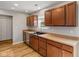 Bright kitchen with stainless steel appliances, wood cabinets, wood-look flooring, and neutral walls at 7163 Cordova Dr, Indianapolis, IN 46221