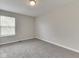 Bright bedroom with neutral walls, a large window, and soft carpet at 7202 Red Lake Ct, Indianapolis, IN 46217