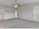 Bedroom features neutral walls, carpeted floors, a ceiling fan, and doors leading to the bathroom at 7202 Red Lake Ct, Indianapolis, IN 46217