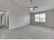 This bedroom offers neutral walls, a ceiling fan, a window, and carpeted floors at 7202 Red Lake Ct, Indianapolis, IN 46217