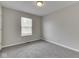 Bedroom with a window, neutral walls, and carpeted floors with light fixture on the ceiling at 7202 Red Lake Ct, Indianapolis, IN 46217