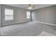 Spacious bedroom featuring neutral paint, plush carpeting, and a modern ceiling fan at 7202 Red Lake Ct, Indianapolis, IN 46217