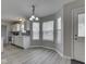 Bright eat-in kitchen area with a charming chandelier and many windows for abundant natural light at 7202 Red Lake Ct, Indianapolis, IN 46217