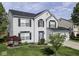 Charming two-story home featuring a well-maintained lawn, complemented by dark shutters and a two-car garage at 7202 Red Lake Ct, Indianapolis, IN 46217
