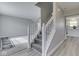 Welcoming foyer with a carpeted staircase, light gray walls and hardwood flooring, leading to the living area at 7202 Red Lake Ct, Indianapolis, IN 46217