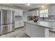 This kitchen features stainless appliances, stone countertops, and tiled backsplash at 7202 Red Lake Ct, Indianapolis, IN 46217
