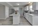 Modern kitchen with stainless appliances, an island with stone countertops, and neutral backsplash at 7202 Red Lake Ct, Indianapolis, IN 46217