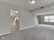 Spacious living room with gray carpet, light gray walls and open layout, connecting seamlessly to other areas at 7202 Red Lake Ct, Indianapolis, IN 46217