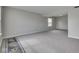 Spacious living room with neutral gray carpet, light gray walls, and natural light streaming through the window at 7202 Red Lake Ct, Indianapolis, IN 46217