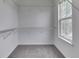 Walk-in closet boasts wire shelving on each wall, carpet flooring and a window for natural light at 7202 Red Lake Ct, Indianapolis, IN 46217