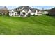 Expansive backyard with manicured lawn and hot tub, ideal for outdoor living and entertaining at 728 Christin Ct, Plainfield, IN 46168