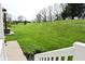 Picturesque backyard featuring a lush lawn, flowerbeds, and access to the home from the deck at 728 Christin Ct, Plainfield, IN 46168