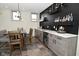 Finished basement bar featuring a beverage fridge, sink, shelves, and space for seating at 728 Christin Ct, Plainfield, IN 46168
