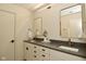 Bright bathroom with double sinks, gray countertop, framed mirrors and modern fixtures at 728 Christin Ct, Plainfield, IN 46168