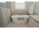 Relaxing bathroom with a modern soaking tub and stylish tile at 728 Christin Ct, Plainfield, IN 46168