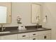 Bright bathroom with double sinks, gray countertop, framed mirrors and modern fixtures at 728 Christin Ct, Plainfield, IN 46168