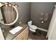 Bathroom with a round mirror, granite countertop, and neutral wallpaper at 728 Christin Ct, Plainfield, IN 46168