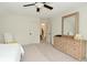 Spacious bedroom with carpet, ceiling fan, dresser with mirror, and neutral color palette at 728 Christin Ct, Plainfield, IN 46168