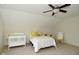 Bright bedroom featuring carpet, a ceiling fan, and a bed, with a crib and rocking chair at 728 Christin Ct, Plainfield, IN 46168