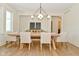 Elegant dining room with modern chandelier, hardwood floors, and seating for six at 728 Christin Ct, Plainfield, IN 46168
